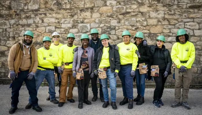 Diverse group of construction workers in safety gear showing workforce inclusivity